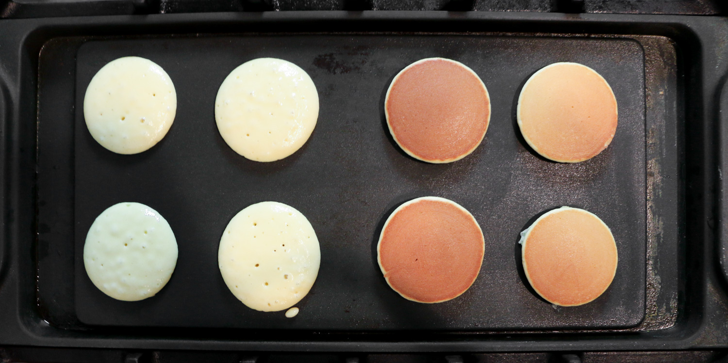 The different stages of cooking dorayaki on a griddle