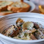 Homemade linguine and clams with creamy white wine sauce and garlic toast